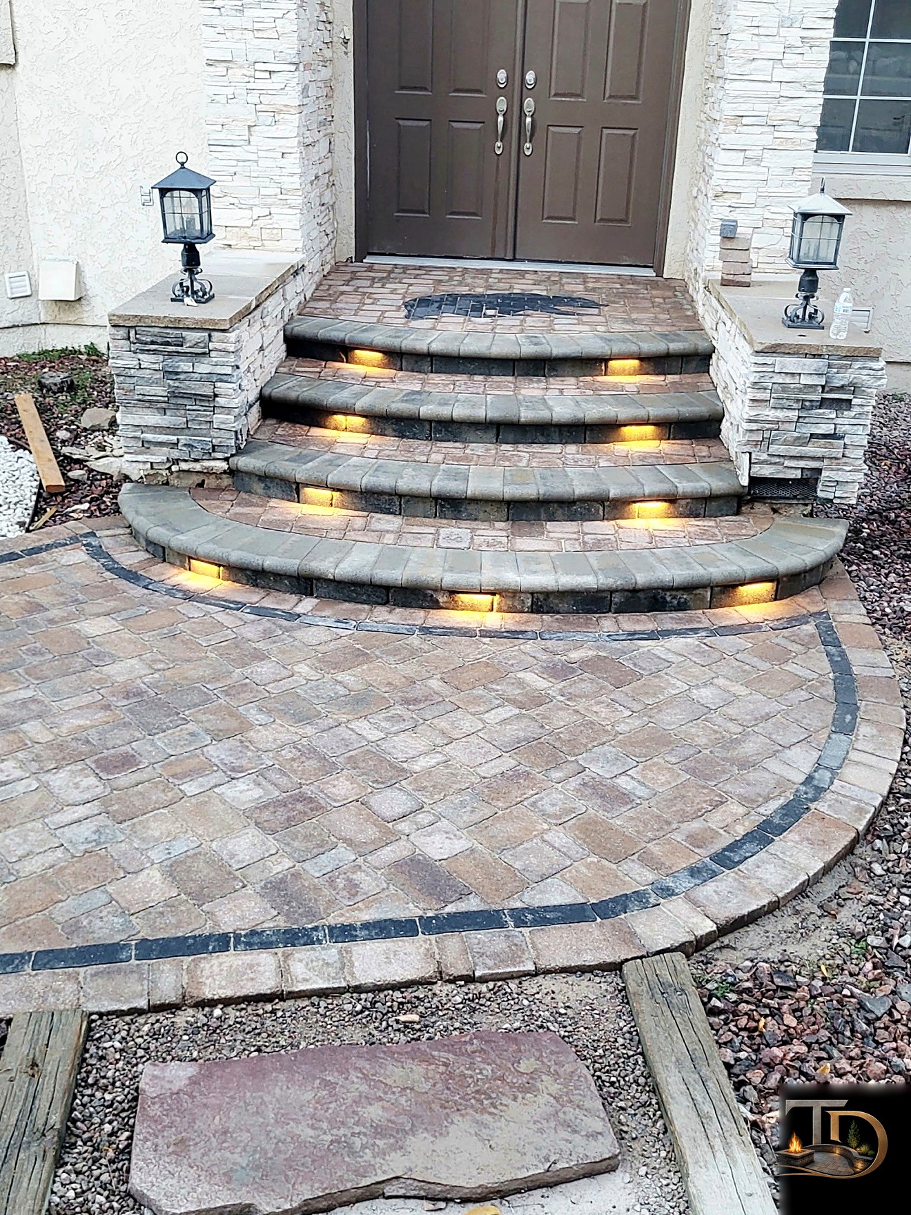 Curved stone entry steps with integrated lighting