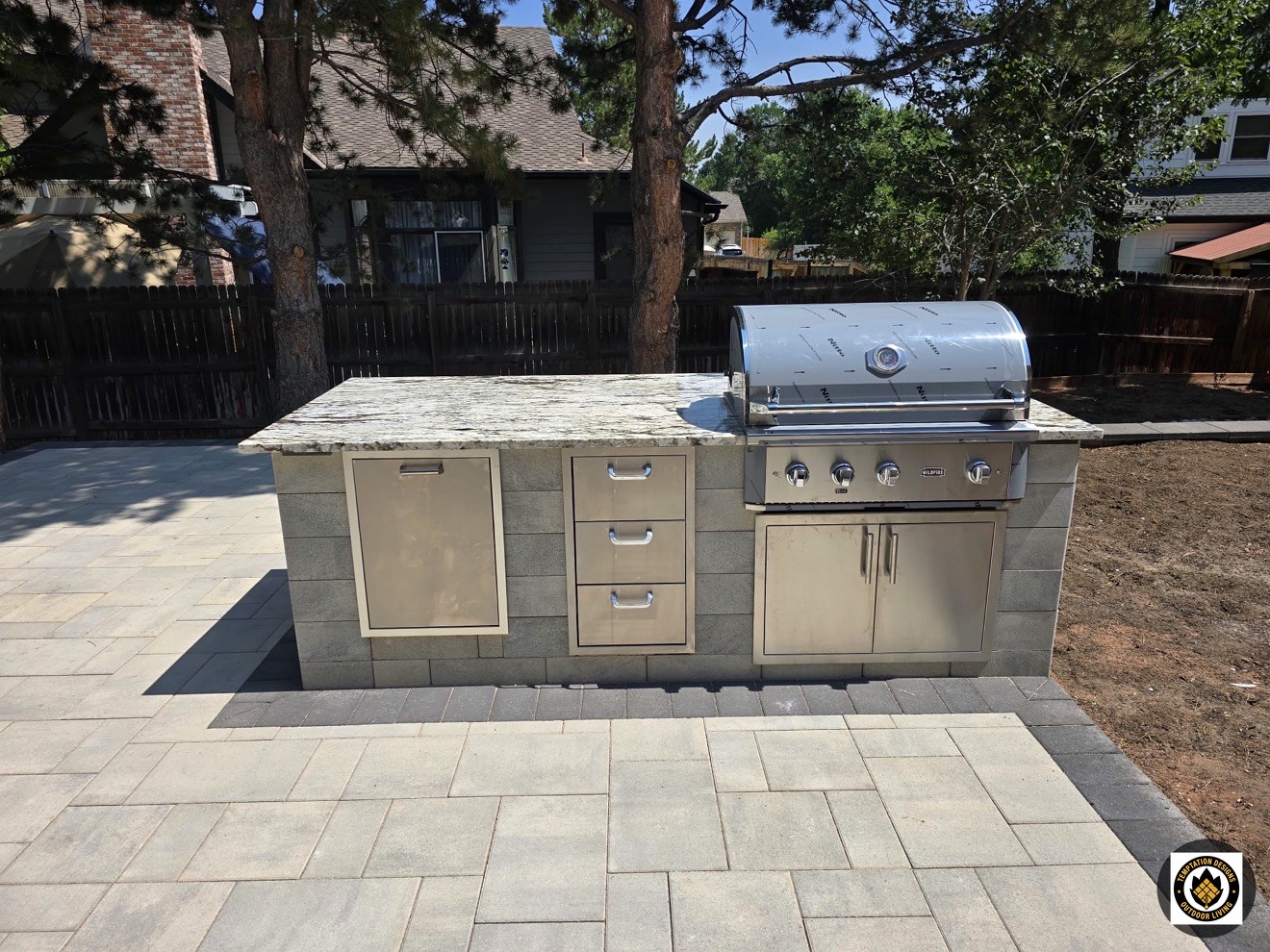 Covered outdoor kitchen with grill and stone counters