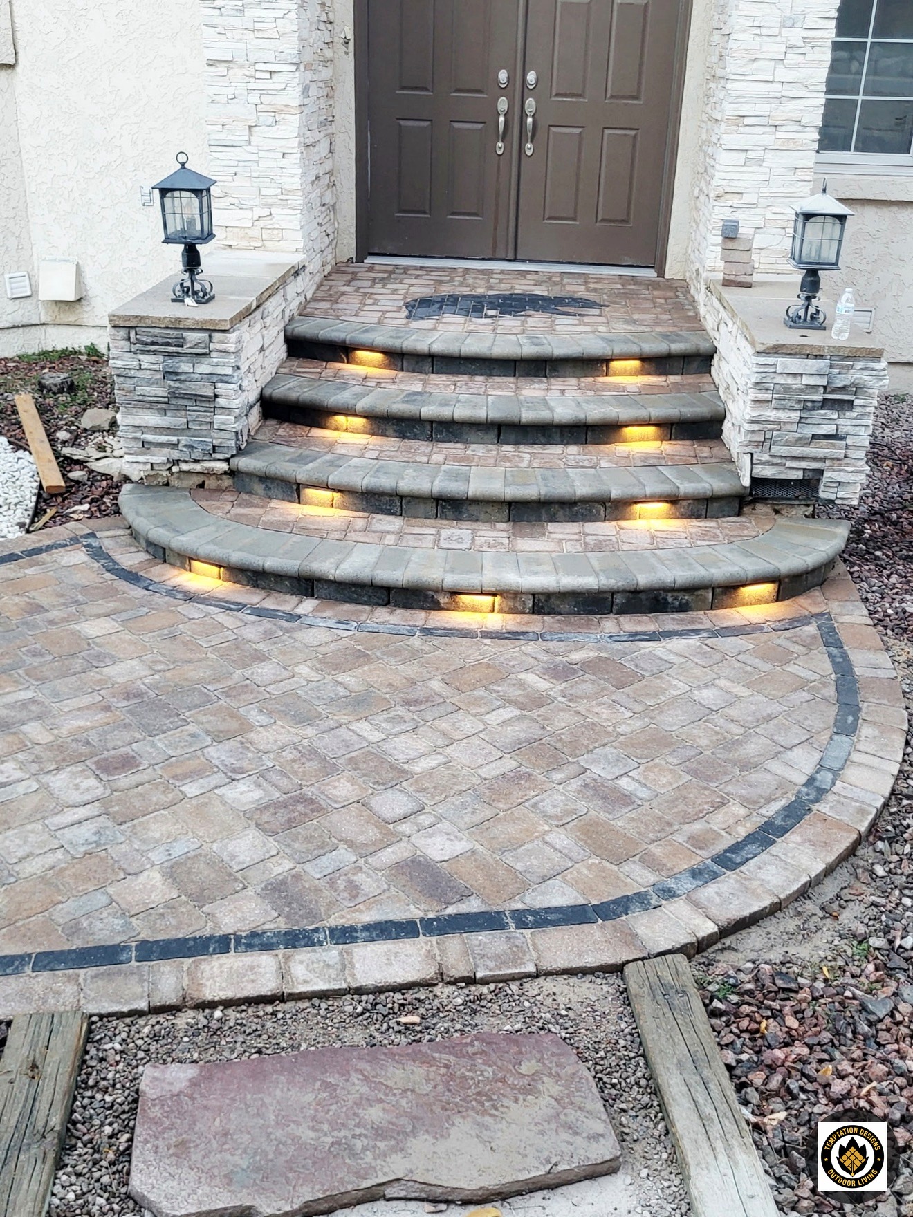 Curved stone entry steps with integrated lighting