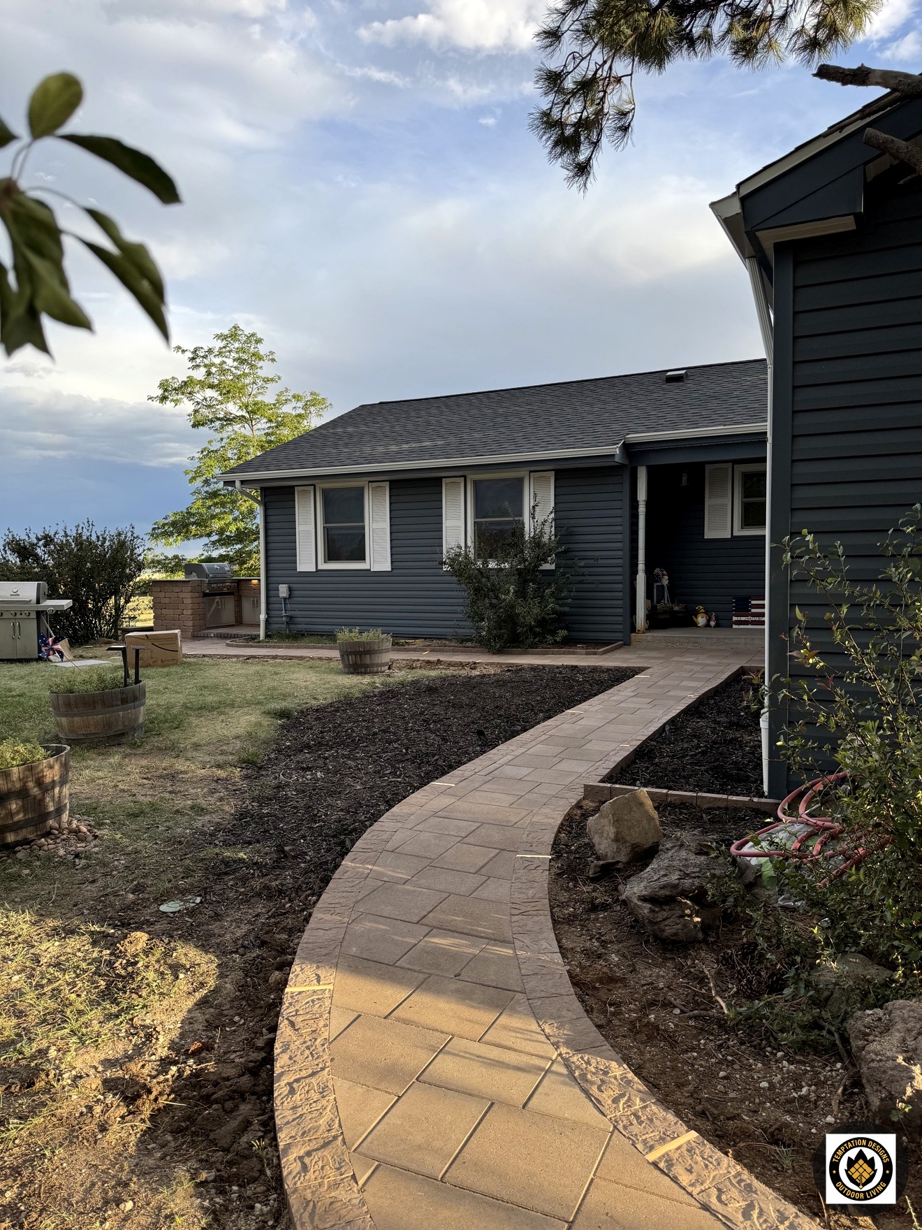 Curved paver walkway beside a home
