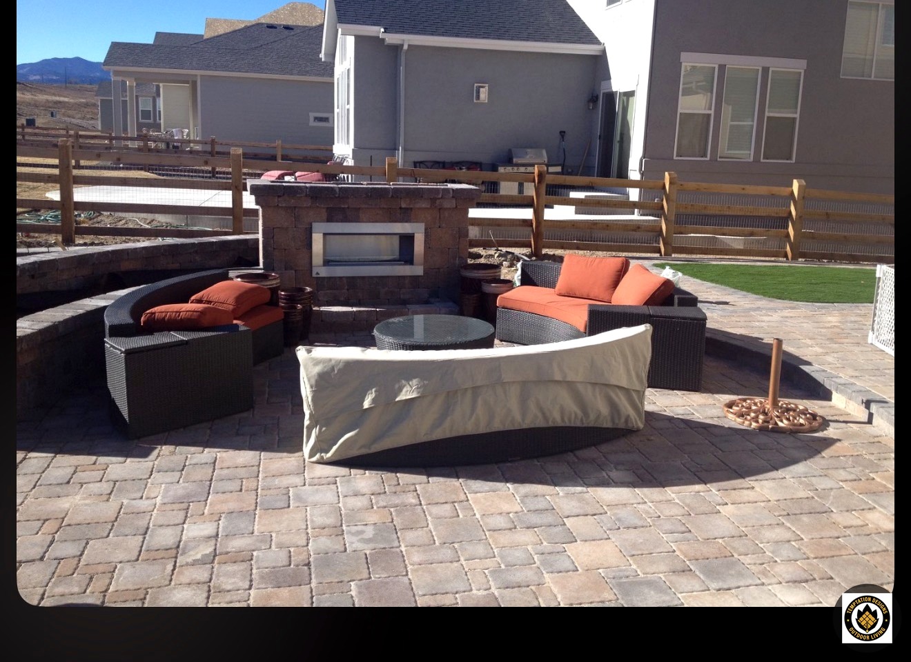 Paver patio with circular fire pit and curved seat wall