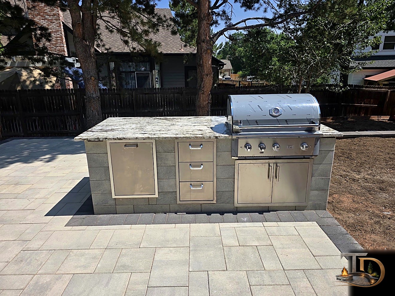 Covered outdoor kitchen with grill and stone counters
