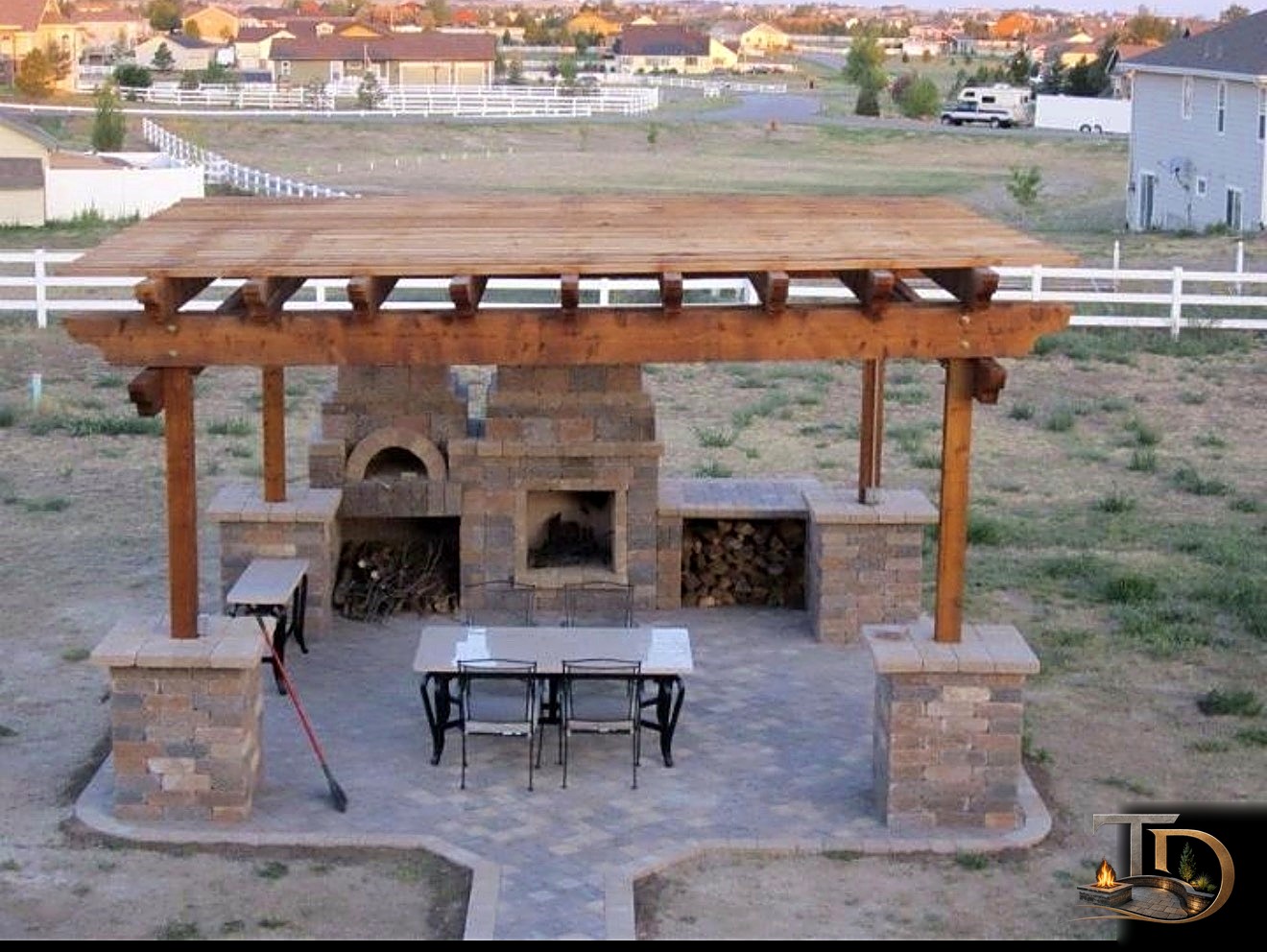 Timber pergola with stone fireplace