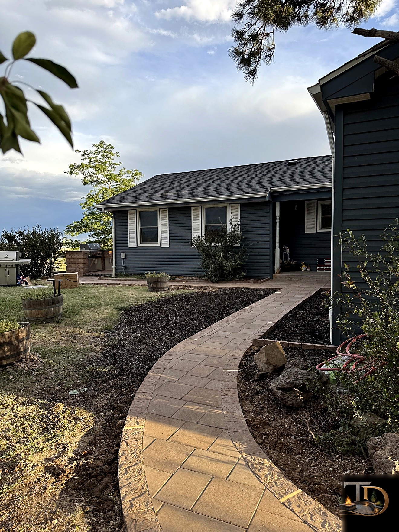 Curved paver walkway beside a home