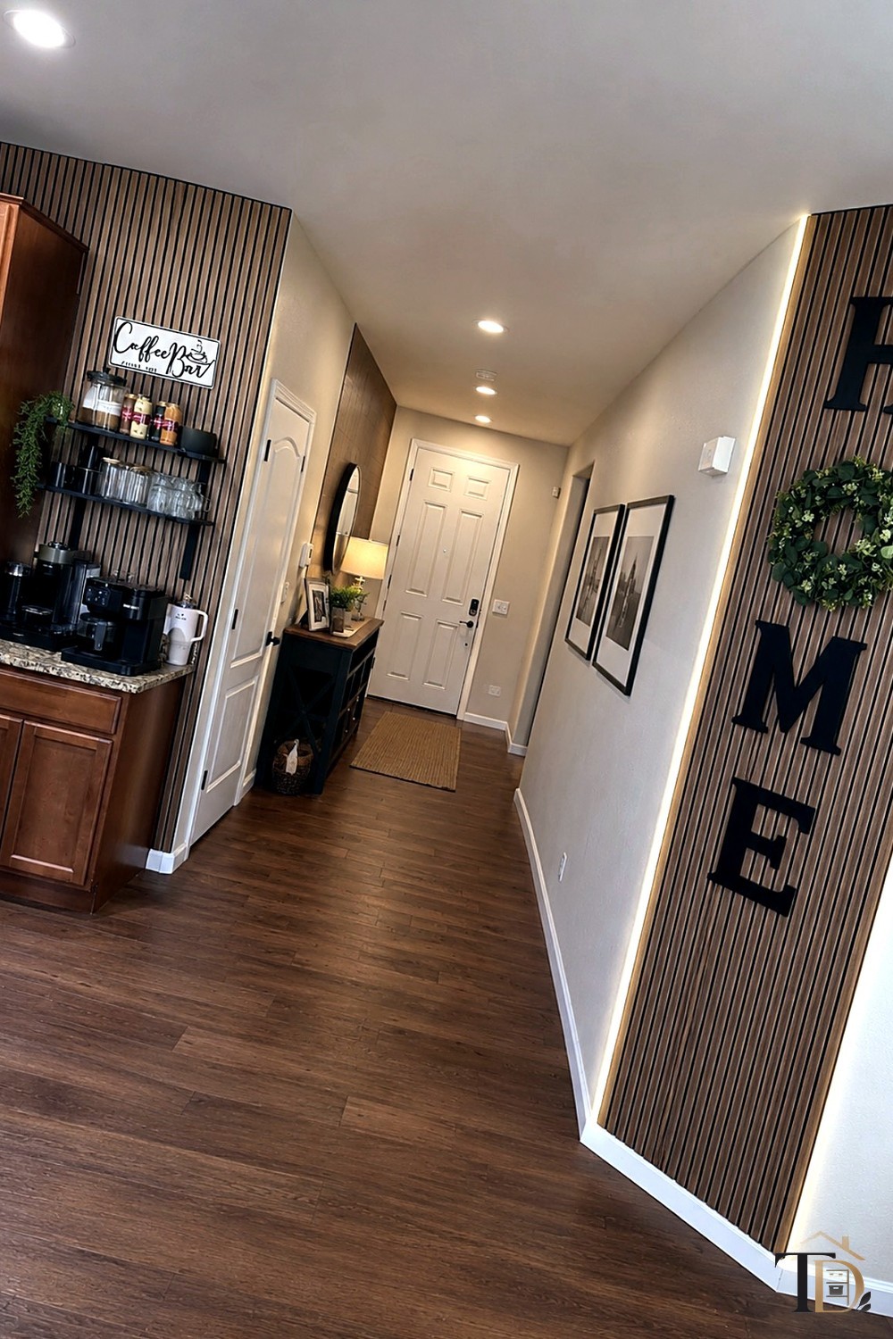 A clear entryway hallway leading to the front door, with nothing staged or stored along the walls