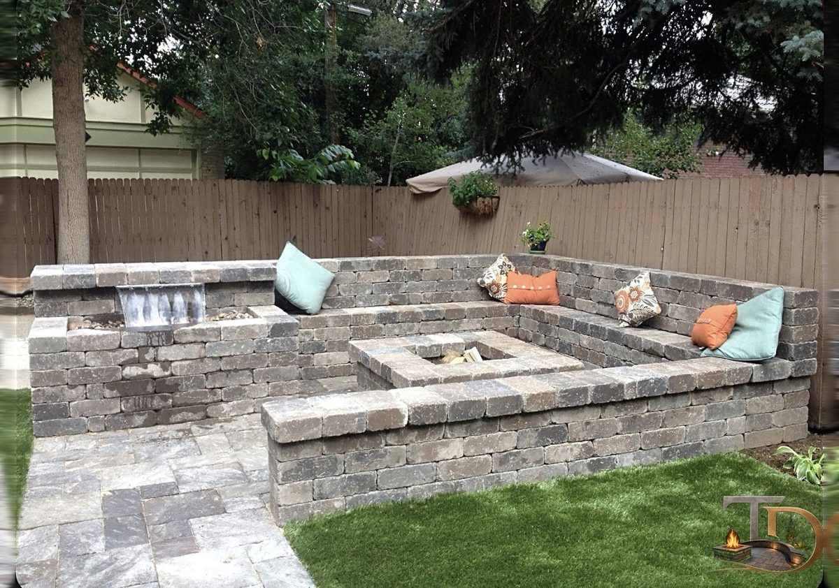 Above-ground block fire pit with cap stones